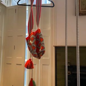 Orange and blue and green bag with tassels.